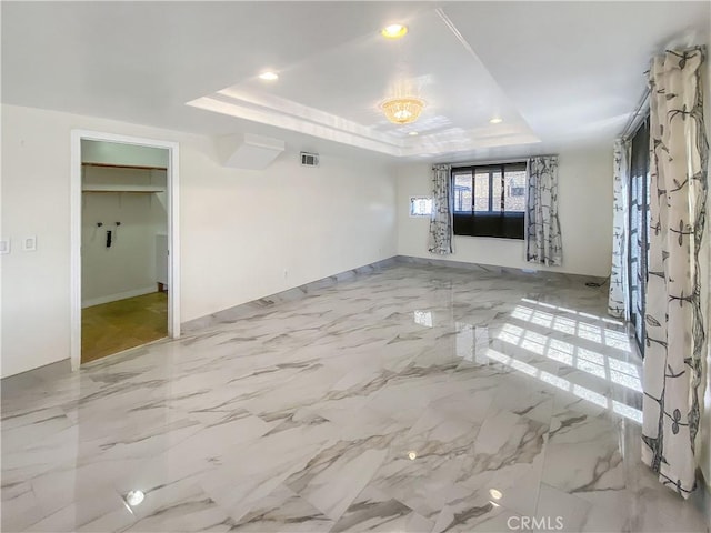 13827 Olathe Rd, Apple Valley, CA 92307 - unfurnished room featuring a raised ceiling, recessed lighting, and baseboards