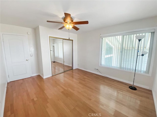 13827 Olathe Rd, Apple Valley, CA 92307 - unfurnished bedroom featuring a closet, light wood-style floors, baseboards, and a ceiling fan