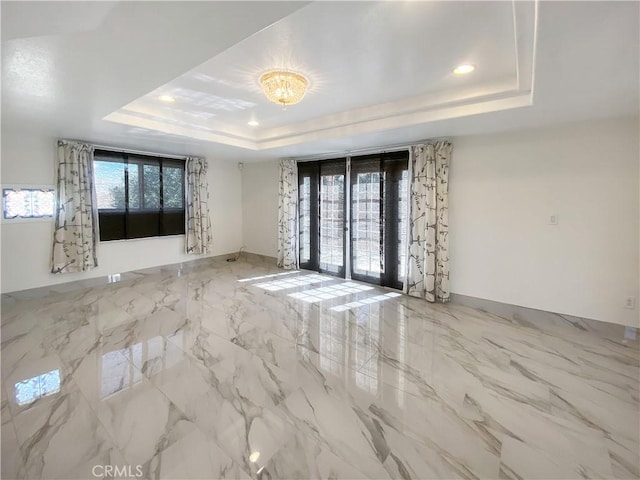 13827 Olathe Rd, Apple Valley, CA 92307 - spare room featuring a raised ceiling, marble tiled floors, and recessed lighting