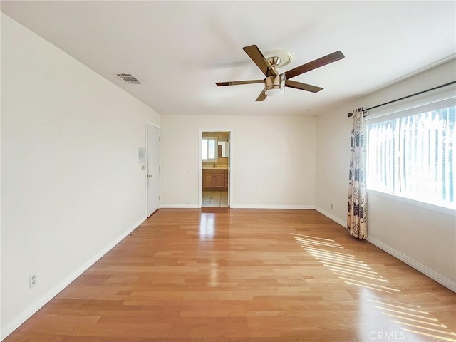 13827 Olathe Rd, Apple Valley, CA 92307 - empty room with a ceiling fan, light wood finished floors, and baseboards