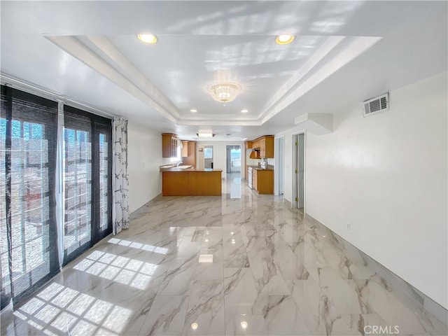 13827 Olathe Rd, Apple Valley, CA 92307 - unfurnished living room featuring a raised ceiling, a chandelier, and recessed lighting