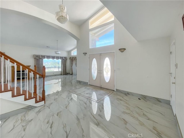 13827 Olathe Rd, Apple Valley, CA 92307 - entryway with arched walkways, marble tiled flooring, stairway, and a chandelier
