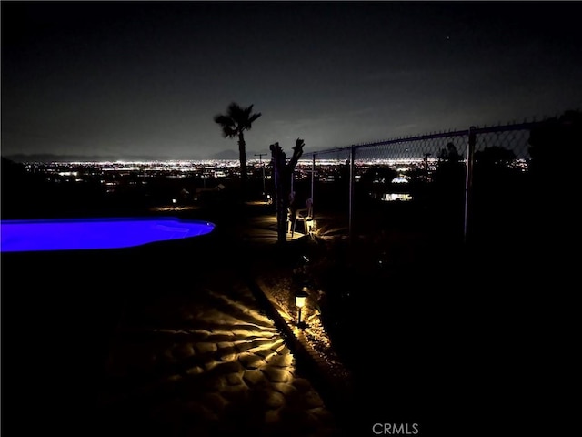 13827 Olathe Rd, Apple Valley, CA 92307 - pool at night with fence