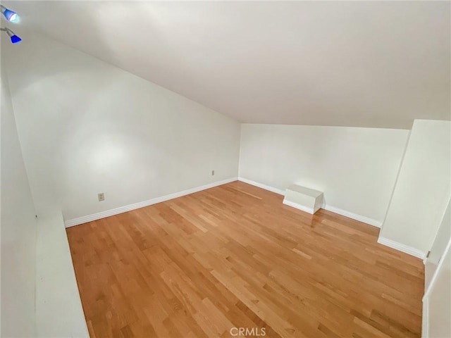 13827 Olathe Rd, Apple Valley, CA 92307 - bonus room featuring light wood finished floors, lofted ceiling, and baseboards