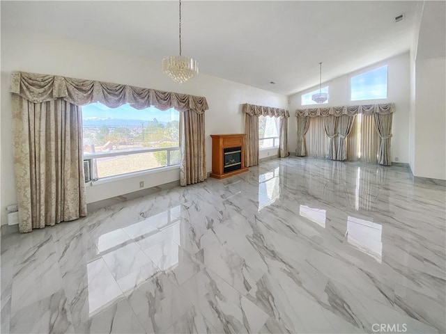 13827 Olathe Rd, Apple Valley, CA 92307 - unfurnished living room with vaulted ceiling, a chandelier, marble tiled flooring, and a fireplace