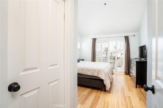 310 Lake St Unit 216, Huntington Beach, CA 92648 - bedroom with vaulted ceiling and light wood-style floors