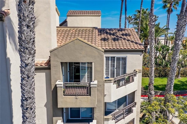310 Lake St Unit 216, Huntington Beach, CA 92648 - back of house with stucco siding and a tile roof