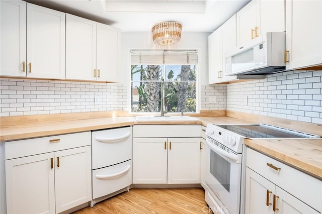 310 Lake St Unit 216, Huntington Beach, CA 92648 - kitchen with white appliances, backsplash, wood counters, light wood finished floors, and a notable chandelier