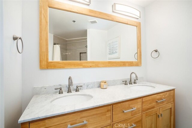310 Lake St Unit 216, Huntington Beach, CA 92648 - full bath with double vanity, a sink, a shower with shower curtain, and visible vents