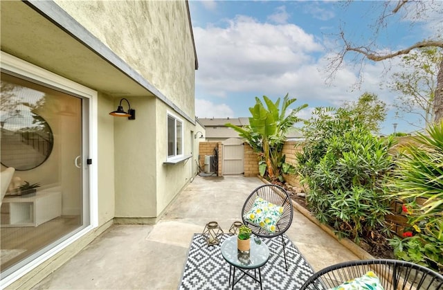 view of patio featuring a gate and fence