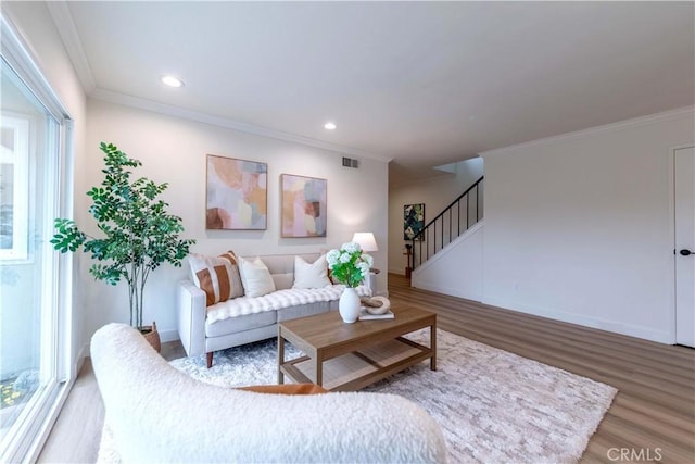 living area featuring stairway, wood finished floors, visible vents, ornamental molding, and recessed lighting