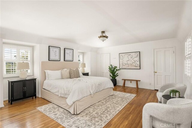 bedroom with baseboards and wood finished floors