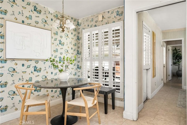 dining room featuring wallpapered walls, a notable chandelier, baseboards, and a healthy amount of sunlight