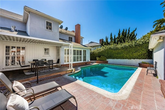 view of swimming pool with fence, a patio area, and a fenced in pool