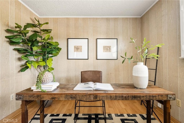 office featuring a textured ceiling, ornamental molding, and wood finished floors