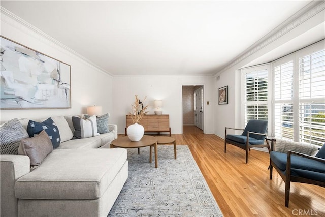 living area with ornamental molding and light wood-type flooring
