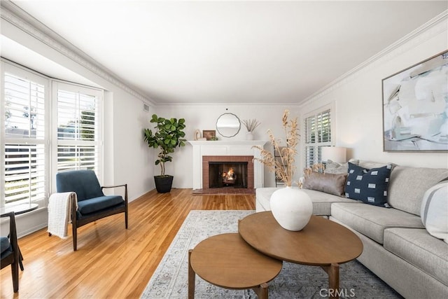 living area featuring ornamental molding, light wood-style floors, and a wealth of natural light