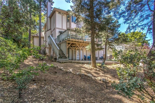 6180 Cedar Ave, Angelus Oaks, CA 92305 - back of house with stairway, a deck, and a chimney