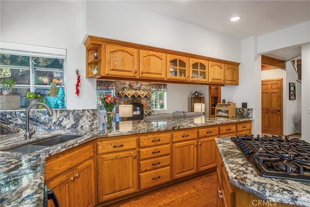 6180 Cedar Ave, Angelus Oaks, CA 92305 - kitchen with black gas cooktop, brown cabinets, dark stone countertops, recessed lighting, and dark wood-style flooring