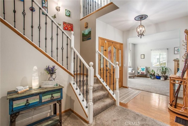6180 Cedar Ave, Angelus Oaks, CA 92305 - entrance foyer with stairway, wood finished floors, carpet, and a chandelier