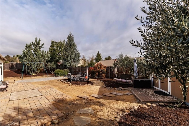 view of yard featuring a fenced backyard, a patio, and a playground