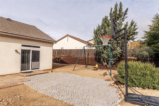 exterior space featuring a fenced backyard and a playground