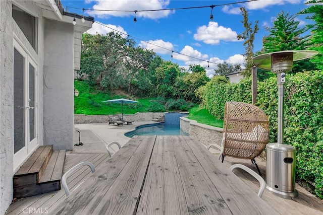 view of swimming pool featuring a deck and a patio area