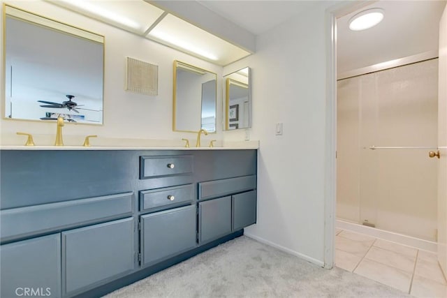bathroom featuring baseboards, a stall shower, double vanity, and ceiling fan