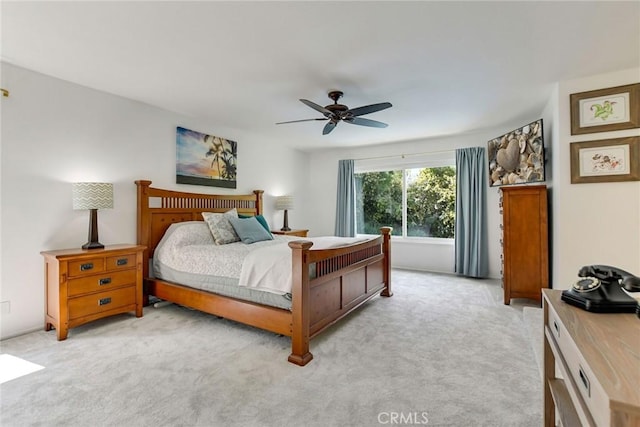 bedroom with light carpet and ceiling fan