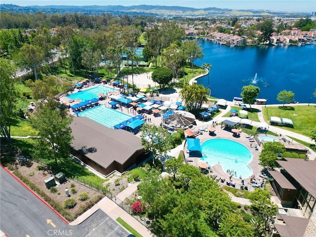 bird's eye view of a pool area and a nearby body of water