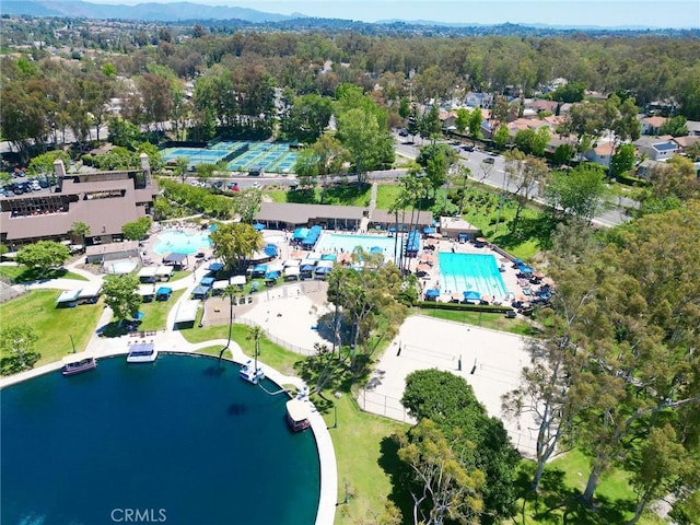 aerial overview of property's location featuring a pool and a nearby body of water