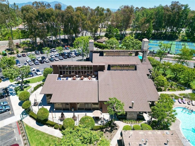 view of subject property with a pool