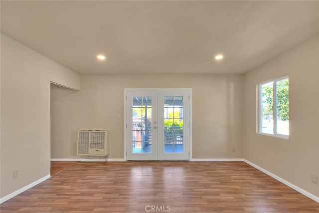 4026 Toland Way, Los Angeles, CA 90065 - unfurnished living room with french doors, wood finished floors, heating unit, recessed lighting, and baseboards