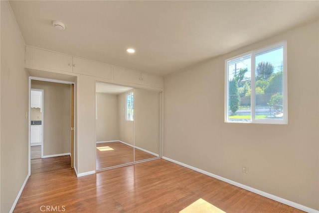 4026 Toland Way, Los Angeles, CA 90065 - unfurnished bedroom with baseboards, wood finished floors, a closet, and recessed lighting