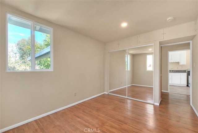 4026 Toland Way, Los Angeles, CA 90065 - unfurnished bedroom with multiple windows, light wood-type flooring, and baseboards