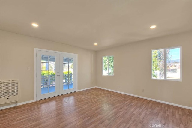4026 Toland Way, Los Angeles, CA 90065 - empty room with wood finished floors, french doors, baseboards, recessed lighting, and heating unit