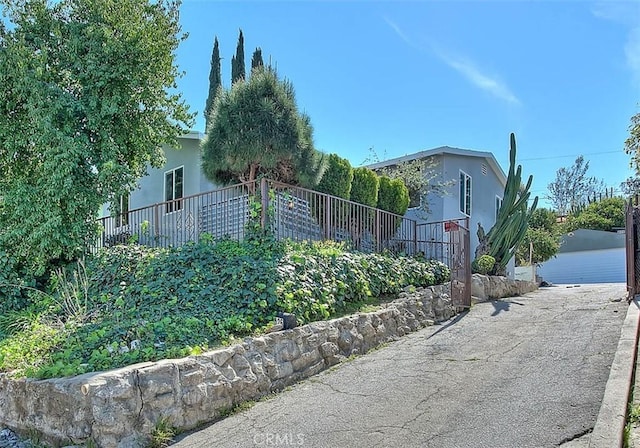 4026 Toland Way, Los Angeles, CA 90065 - view of property exterior featuring stucco siding, fence, and a garage