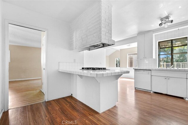 21032 Baltar St, Canoga Park, CA 91304 - kitchen featuring dishwasher, tile counters, a peninsula, and dark wood-type flooring