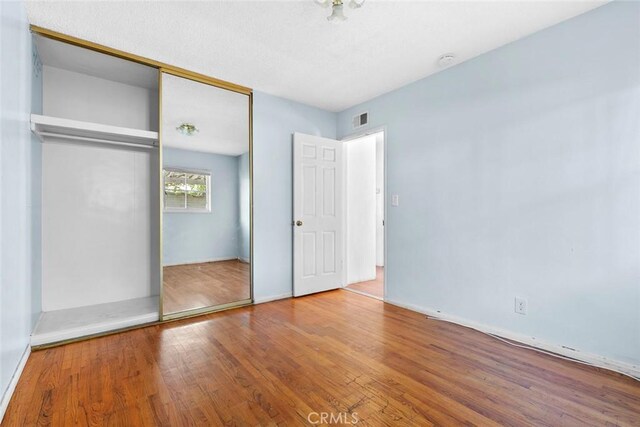 21032 Baltar St, Canoga Park, CA 91304 - unfurnished bedroom featuring wood finished floors, a closet, and visible vents