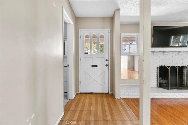21032 Baltar St, Canoga Park, CA 91304 - foyer featuring light wood-type flooring and a textured ceiling