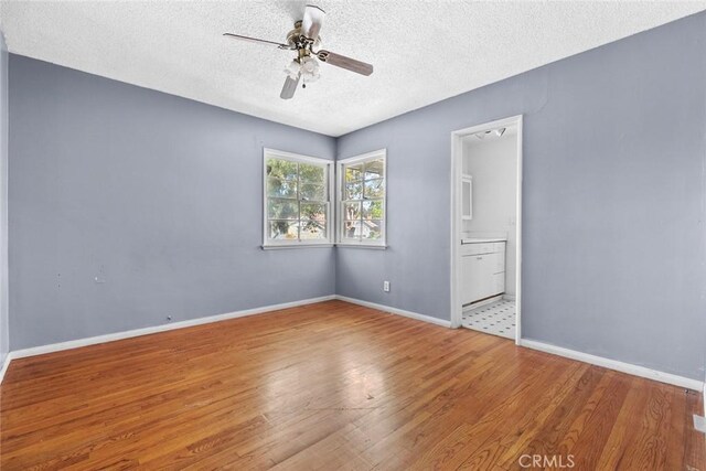 21032 Baltar St, Canoga Park, CA 91304 - unfurnished room featuring a textured ceiling, baseboards, ceiling fan, and wood finished floors