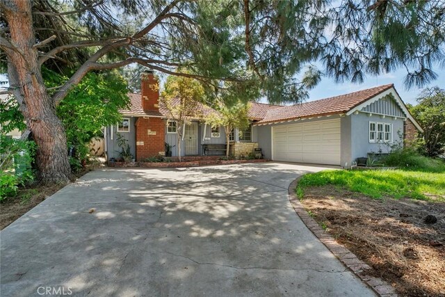21032 Baltar St, Canoga Park, CA 91304 - ranch-style house with a chimney, driveway, stucco siding, and an attached garage