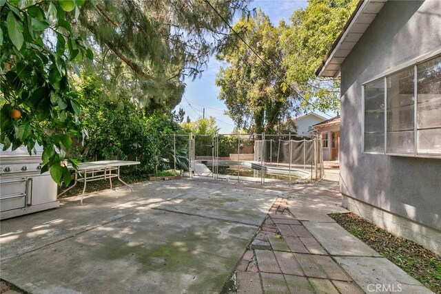 21032 Baltar St, Canoga Park, CA 91304 - view of patio with a trampoline and fence