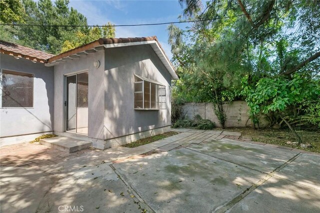 21032 Baltar St, Canoga Park, CA 91304 - exterior space with stucco siding, fence, a tiled roof, and a patio