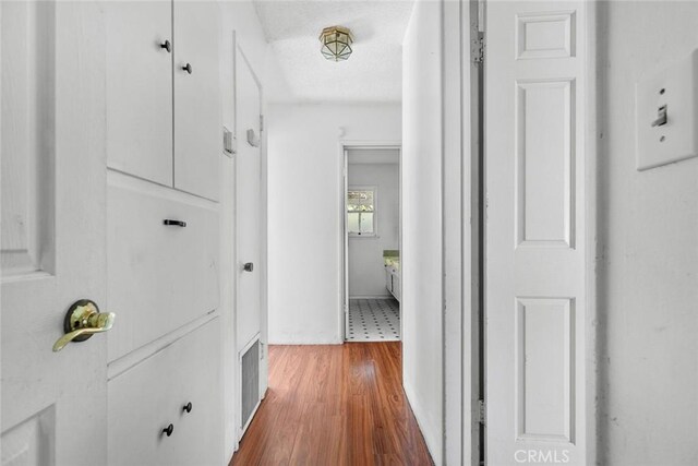 21032 Baltar St, Canoga Park, CA 91304 - corridor featuring visible vents, a textured ceiling, and wood finished floors