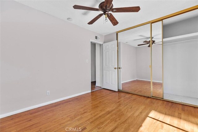 21032 Baltar St, Canoga Park, CA 91304 - unfurnished bedroom featuring baseboards, visible vents, a ceiling fan, a closet, and wood finished floors
