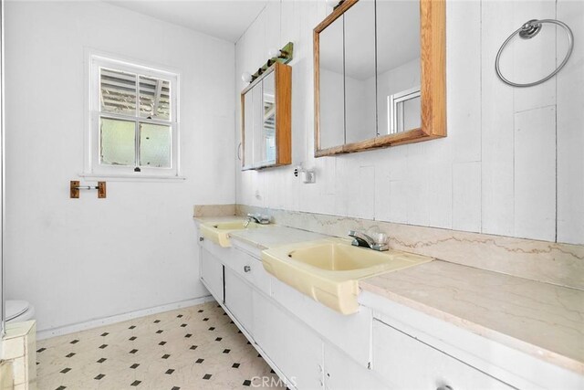 21032 Baltar St, Canoga Park, CA 91304 - bathroom featuring toilet, double vanity, a sink, and tile patterned floors