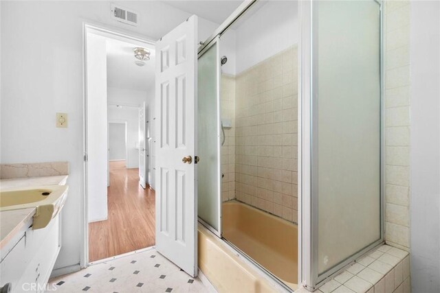 21032 Baltar St, Canoga Park, CA 91304 - full bath with tile patterned floors, vanity, shower / bath combination with glass door, and visible vents