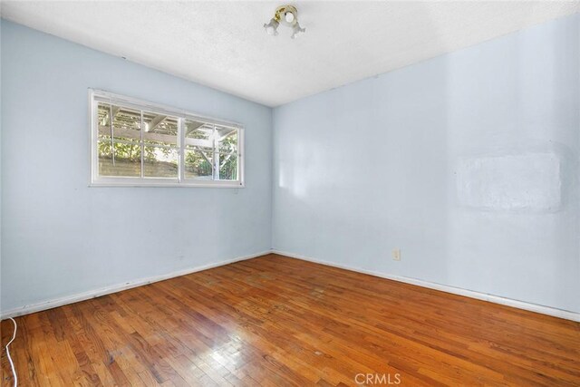 21032 Baltar St, Canoga Park, CA 91304 - empty room featuring baseboards and wood-type flooring