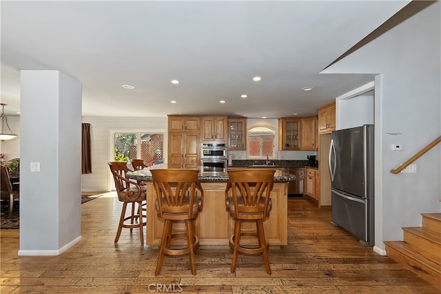 279 Bluebird Ct, Big Bear Lake, CA 92315 - kitchen featuring dark wood-style flooring, stainless steel appliances, a kitchen island, glass insert cabinets, and a sink